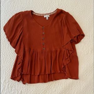 A burnt orange top. A girls XL.
